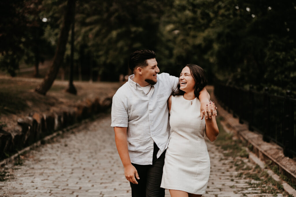 Couples walks down cobblestone path, laughing, leaving Pittsburghs Phipps Botanical Garden