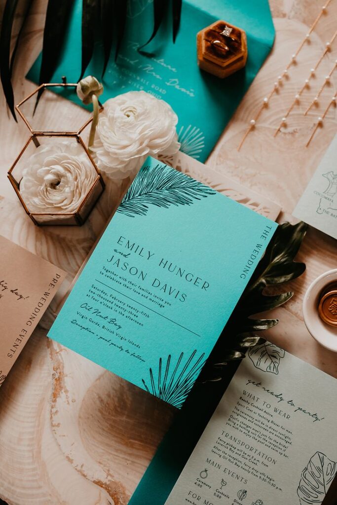 Teal-colored stationery card that describes the details of the couple's wedding in the Virgin Islands