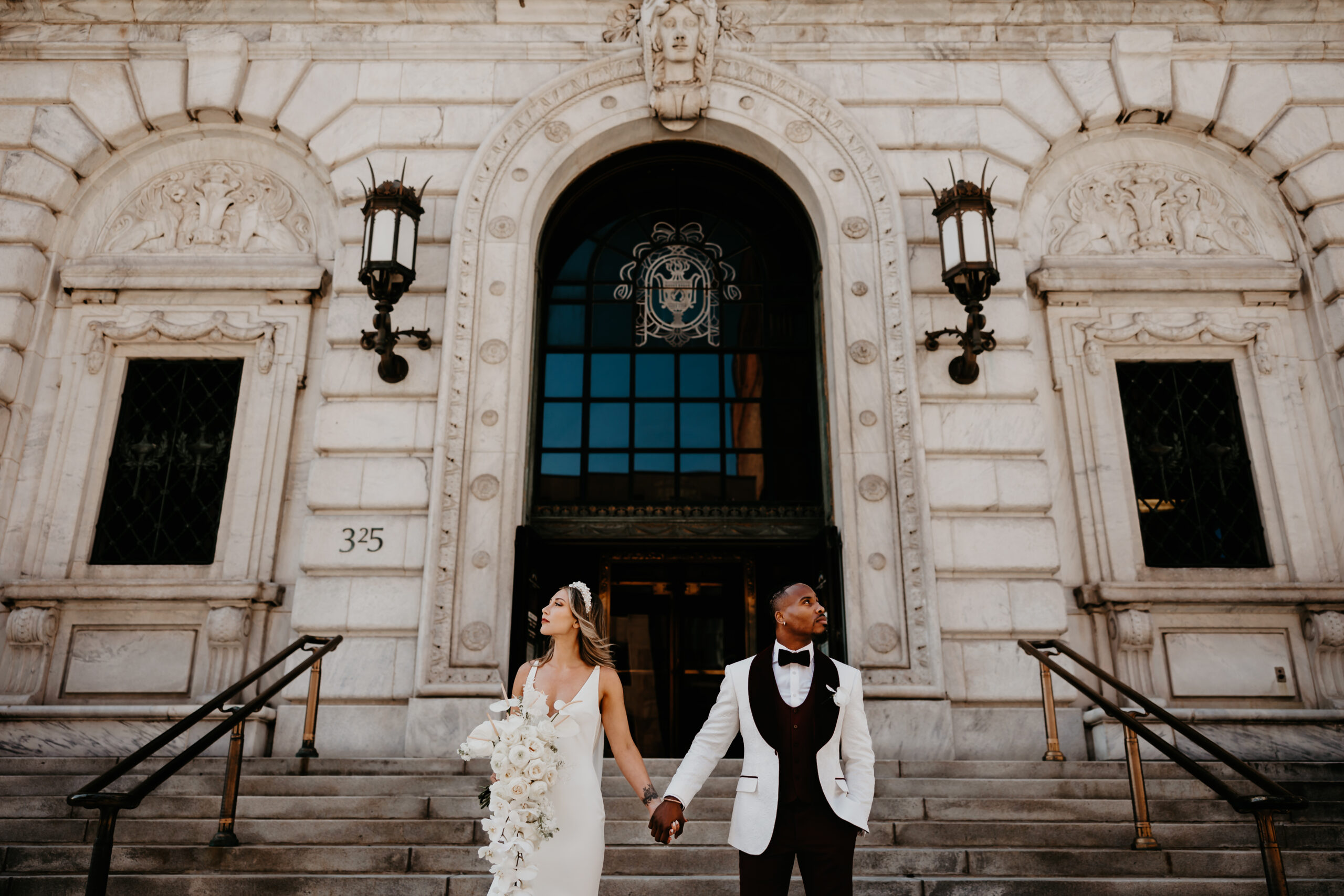 Chic Bride and Groom pose for portraits in front of The Cleveland Public Library